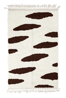 Brush Stride zebra stripe wool rug, dark brown stripes on cream, full view from above with fringed ends