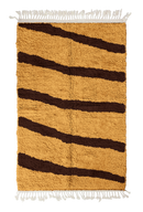 Open Stride zebra stripe wool rug, dark brown stripes on ochre yellow, full view from above with fringed ends