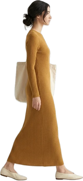 Woman walking in a long ochre knit dress